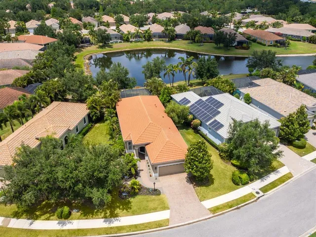 an aerial view of a house with yard swimming pool and outdoor seating