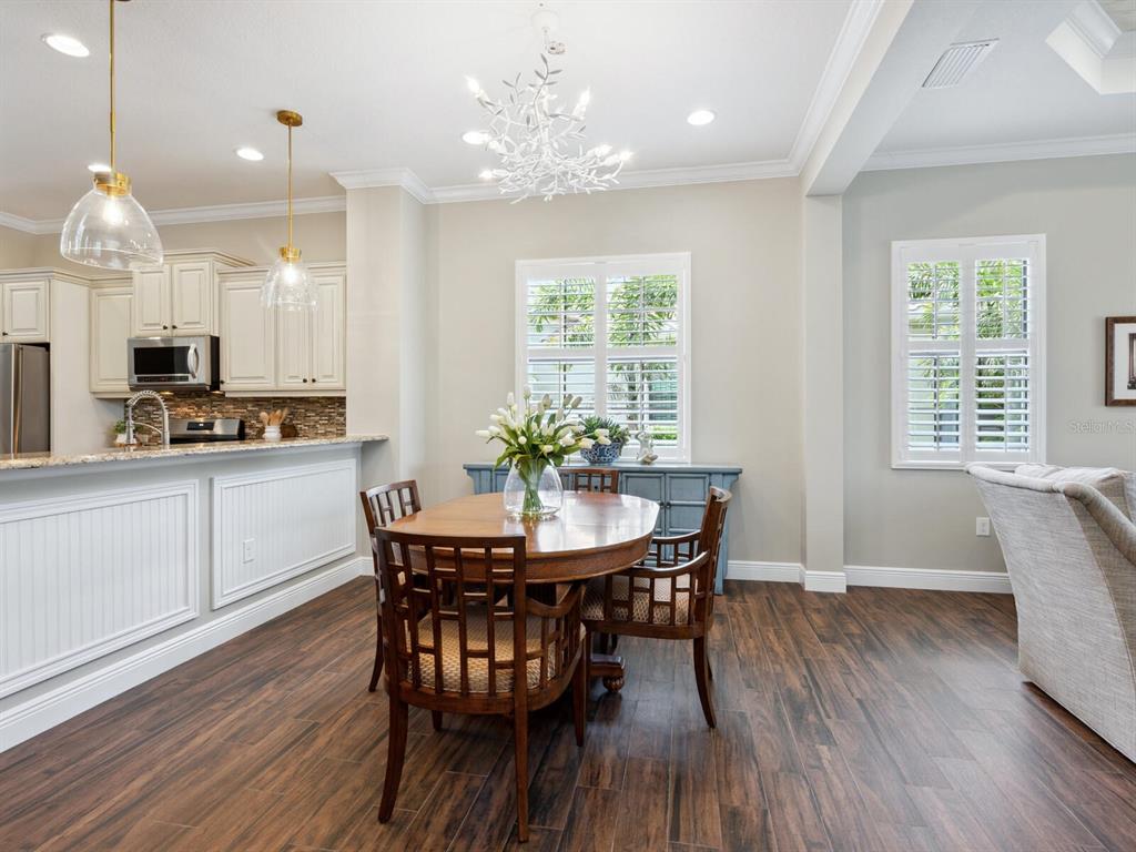 14325 Stirling Drive Lakewood Ranch, FL 34202 - Photo 12 of 53 a view of a dining room with furniture window and wooden floor