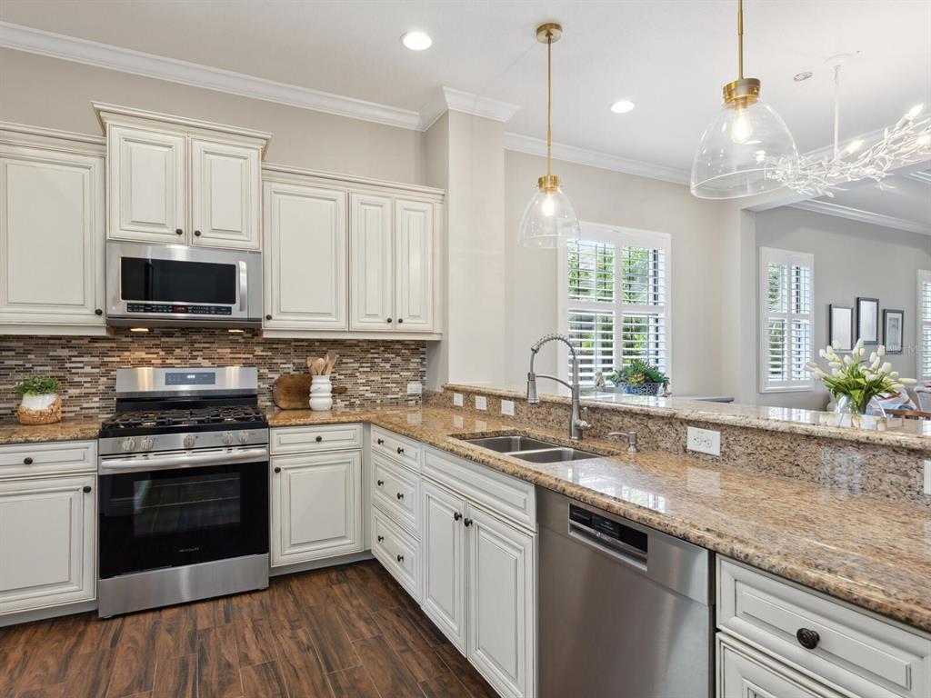 14325 Stirling Drive Lakewood Ranch, FL 34202 - Photo 15 of 53 a kitchen with a sink stove and cabinets