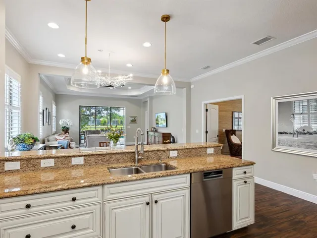a kitchen with center island and large windows