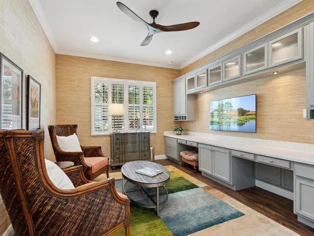 a living room with furniture a flat screen tv and windows