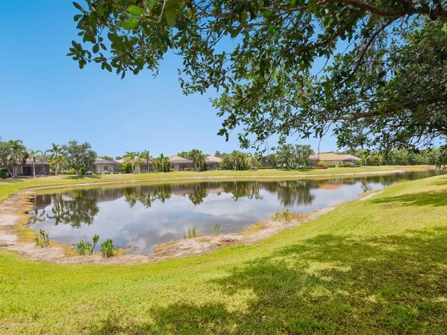 a view of a lake with houses in the back
