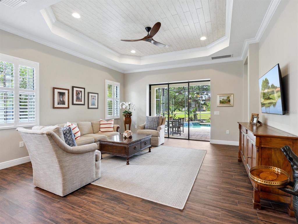 14325 Stirling Drive Lakewood Ranch, FL 34202 - Photo 8 of 53 a living room with furniture and a flat screen tv