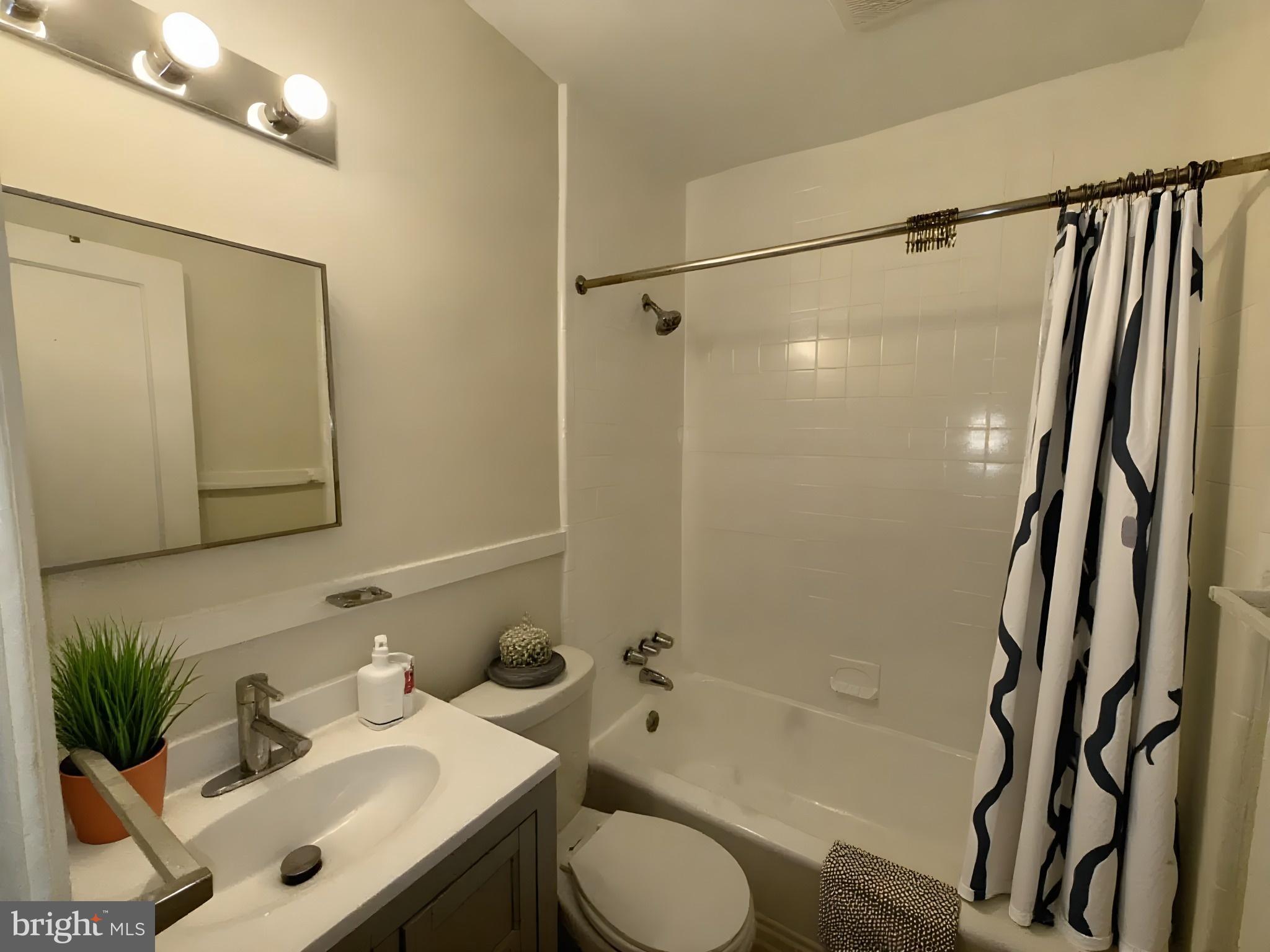 102 O Street Southwest, Unit 1 Washington, DC 20024 - Photo 3 of 5 a bathroom with a sink toilet and shower