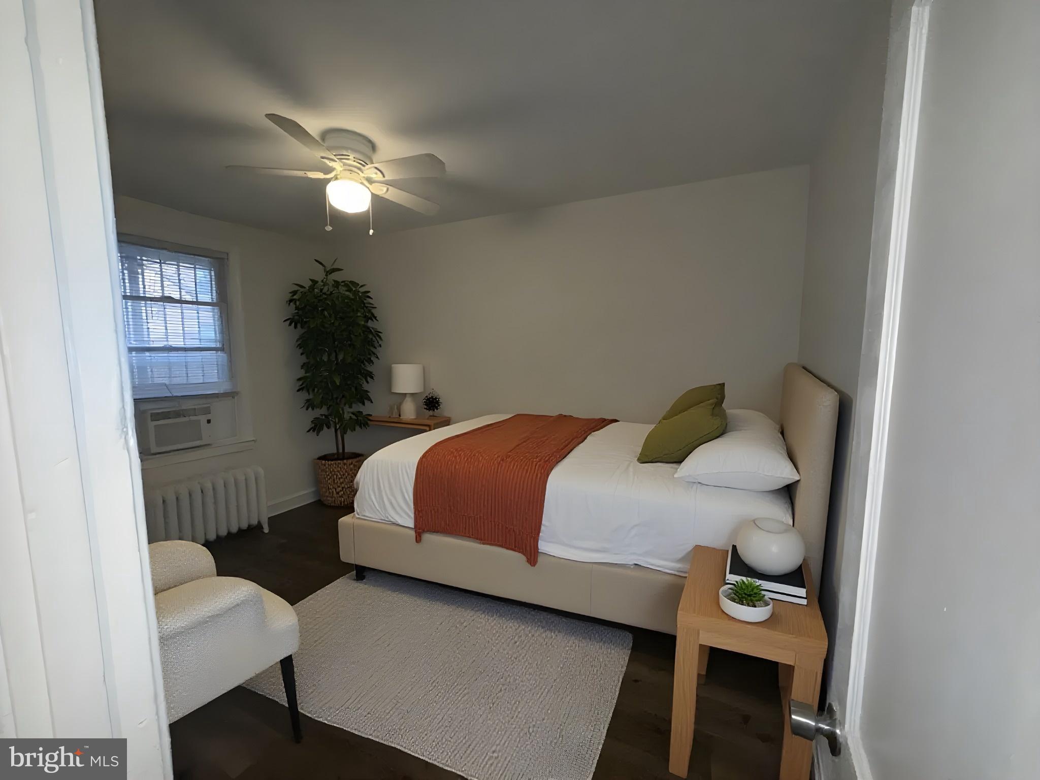 102 O Street Southwest, Unit 1 Washington, DC 20024 - Photo 4 of 5 a bedroom with a bed and a chandelier