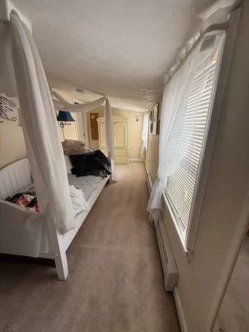 a view of a livingroom with wooden floor and furniture