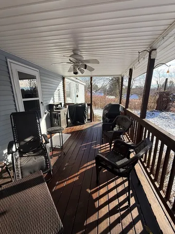 a view of a patio with dining table and chairs with wooden floor