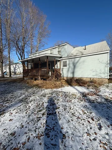 a view of dirt yard with a large tree