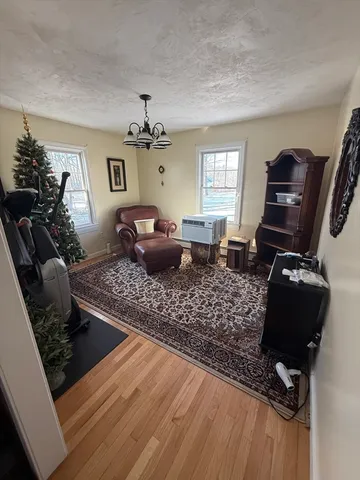 a living room with furniture rug and a window