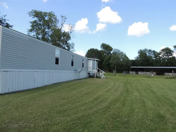 a view of backyard with trampoline