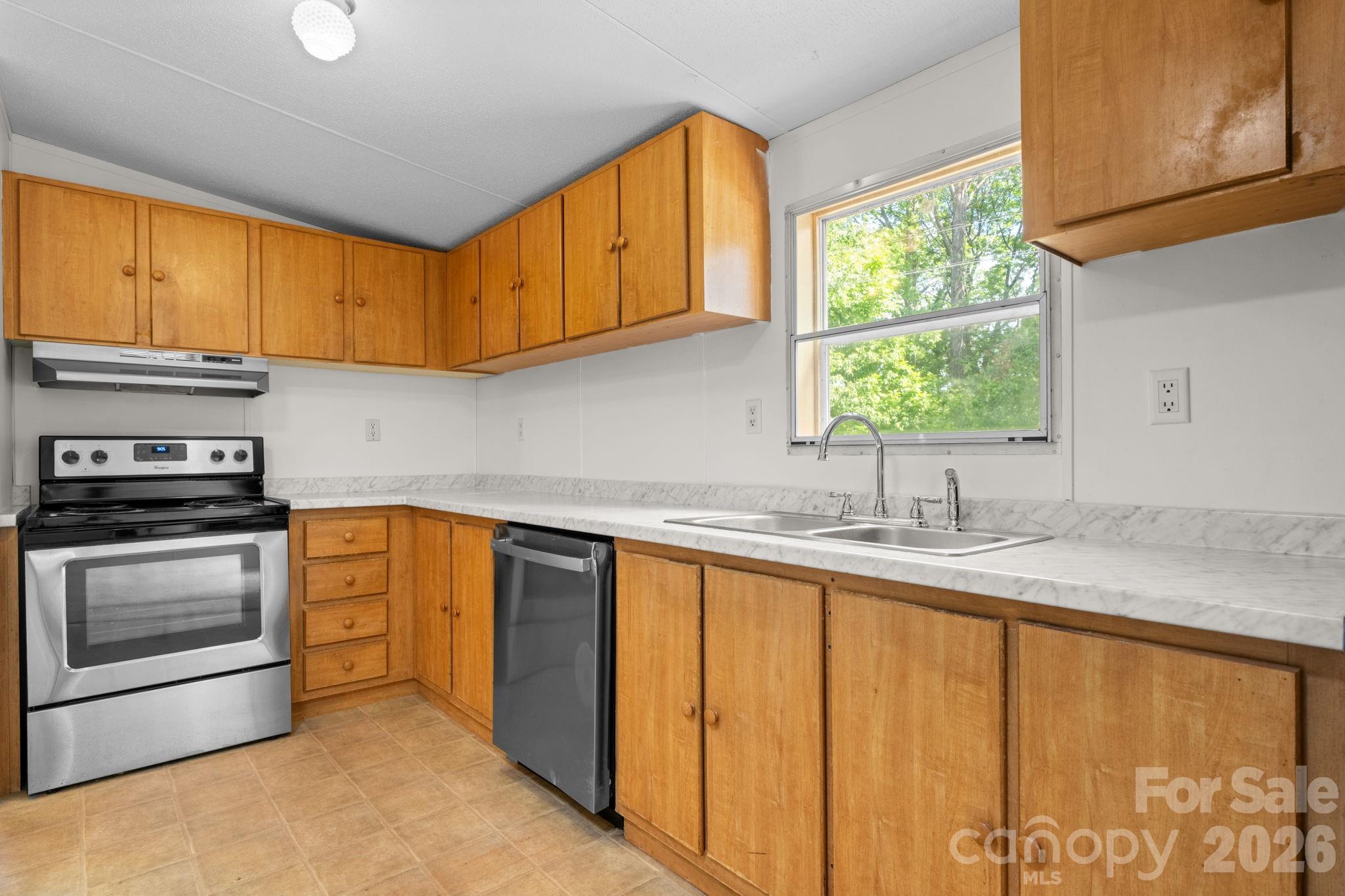 3536 Nelson Lane Morganton, NC 28655 - Photo 11 of 33 a kitchen with stainless steel appliances granite countertop a sink a stove and a microwave oven