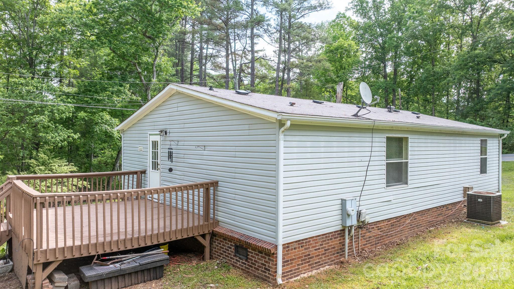 3536 Nelson Lane Morganton, NC 28655 - Photo 32 of 33 a view of a house with a small deck and a yard