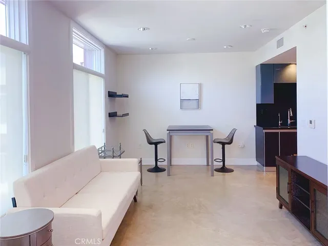 a living room with furniture and a lamp