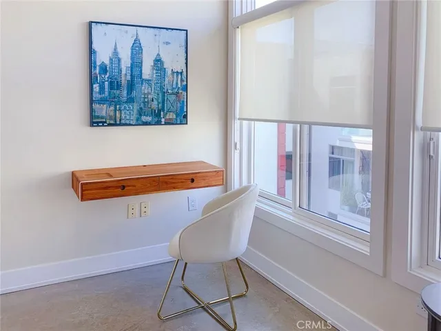 a front view of a house with wooden floor and a painting on the wall