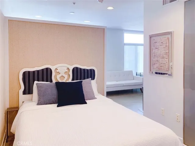 a bedroom with a bed and a couch