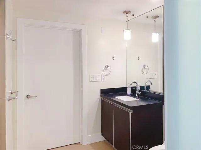 a bathroom with a sink vanity and a mirror