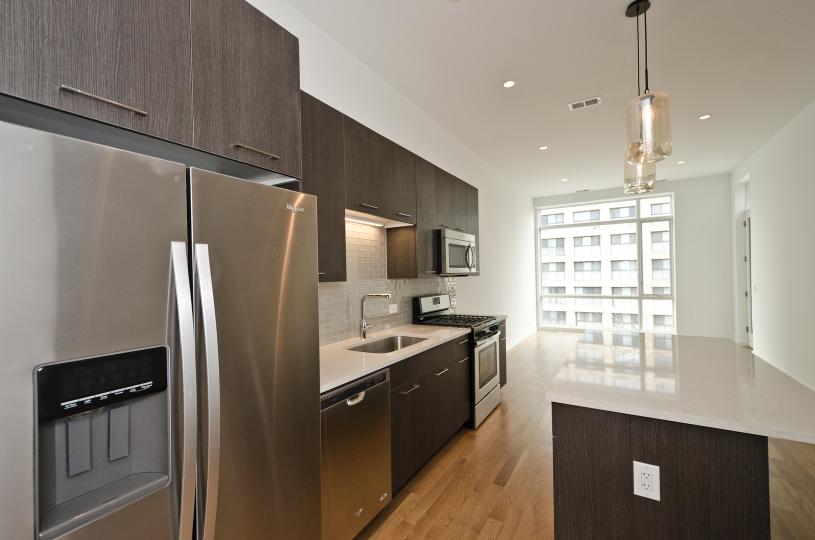 Undisclosed Address Chicago, IL 60642 - Photo 11 of 14 a kitchen with stainless steel appliances granite countertop a refrigerator a sink a stove and a refrigerator