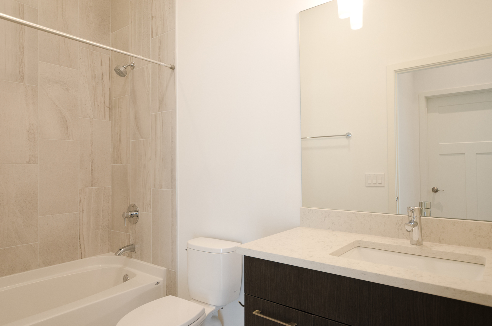 Undisclosed Address Chicago, IL 60642 - Photo 14 of 14 a bathroom with a granite countertop sink toilet and shower