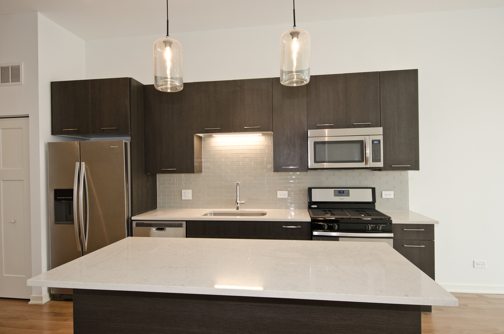 Undisclosed Address Chicago, IL 60642 - Photo 2 of 14 a kitchen with stainless steel appliances a refrigerator sink and microwave