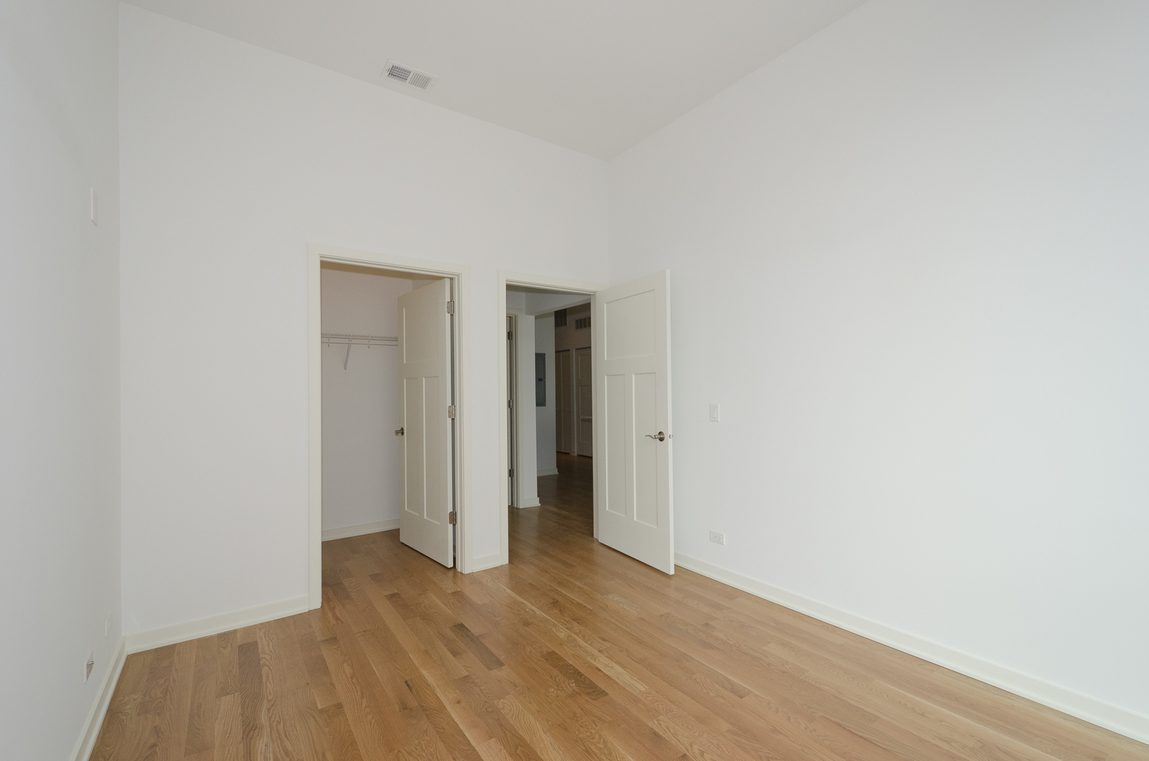Undisclosed Address Chicago, IL 60642 - Photo 4 of 14 a view of an empty room with wooden floor and closet