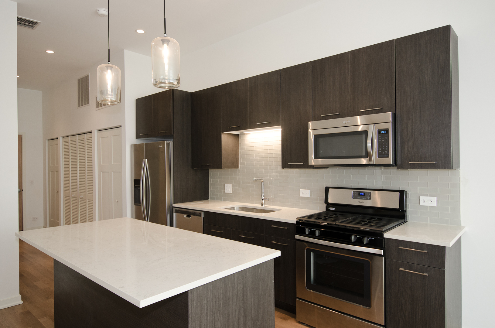 Undisclosed Address Chicago, IL 60642 - Photo 6 of 14 a kitchen with stainless steel appliances a stove microwave and refrigerator