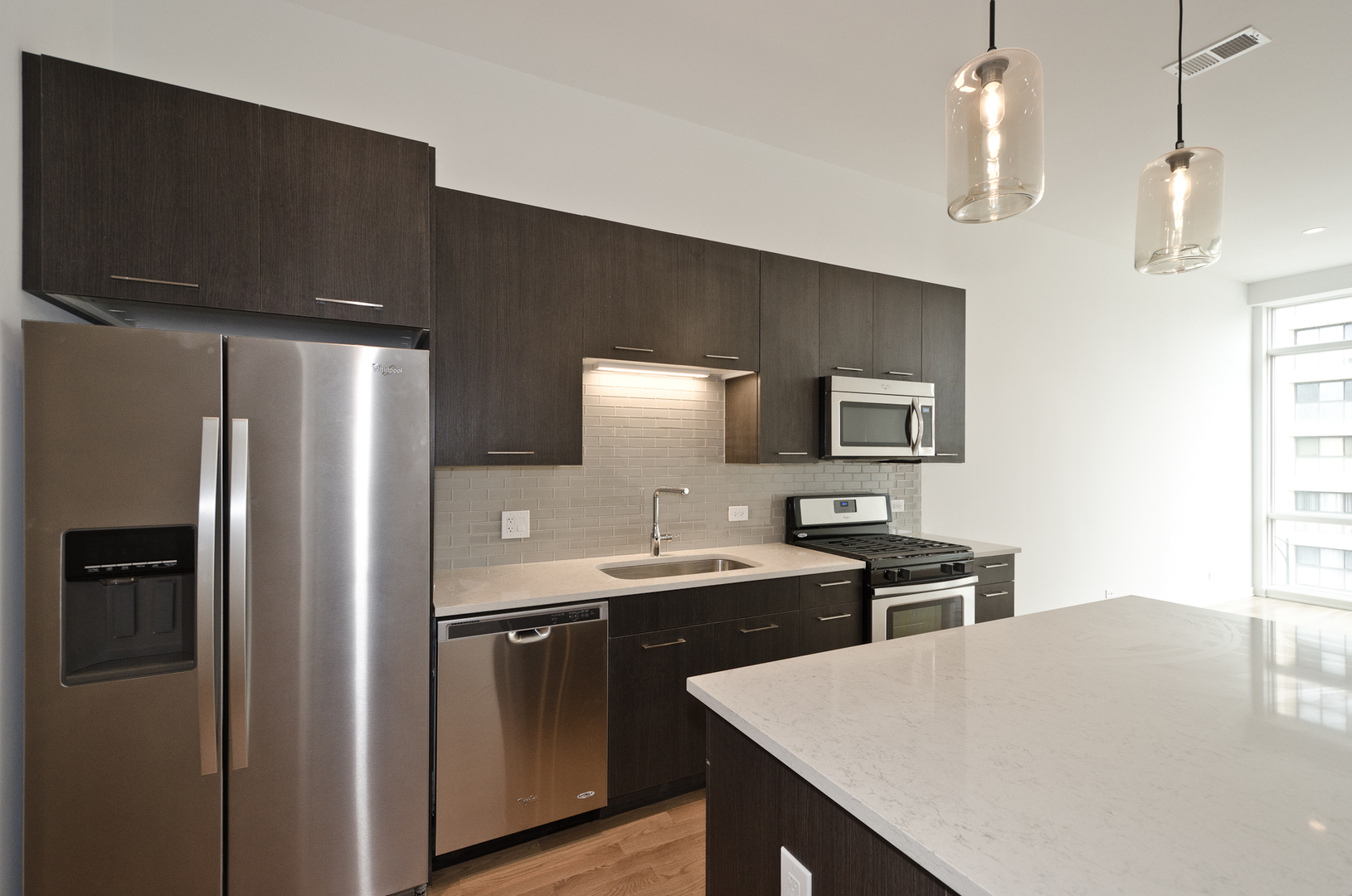 Undisclosed Address Chicago, IL 60642 - Photo 10 of 14 a kitchen with stainless steel appliances granite countertop a sink stove and refrigerator