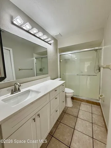 a bathroom with a glass shower door