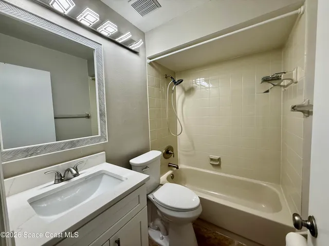a bathroom with a toilet sink and a mirror