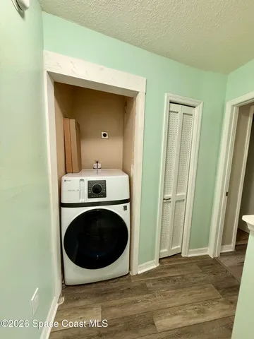 a view of empty room with wooden floor and fireplace