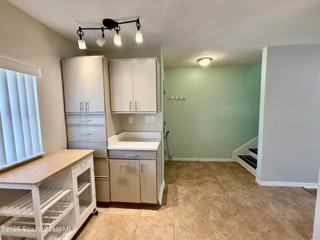 a view of kitchen with sink and wooden floor