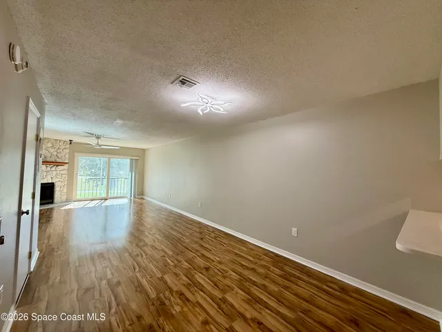 a view of a room with wooden floor