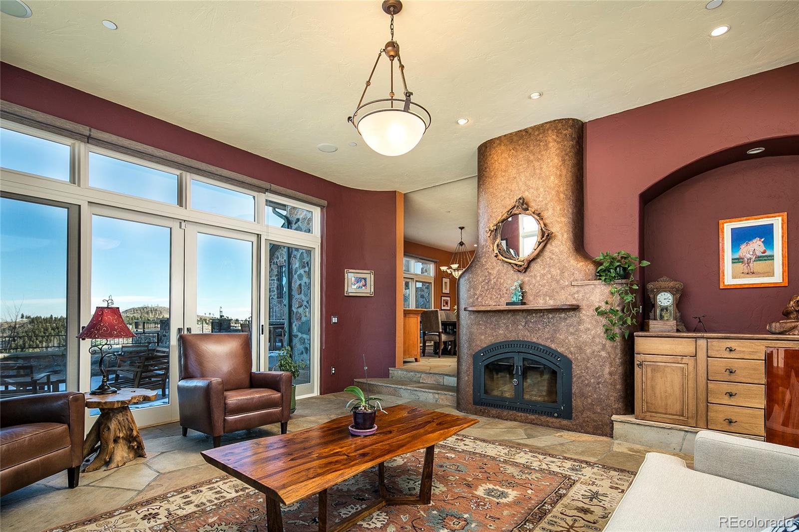 355 Mountain King Road Boulder, CO 80302 - Photo 12 of 33 a living room with furniture a fireplace and a floor to ceiling window