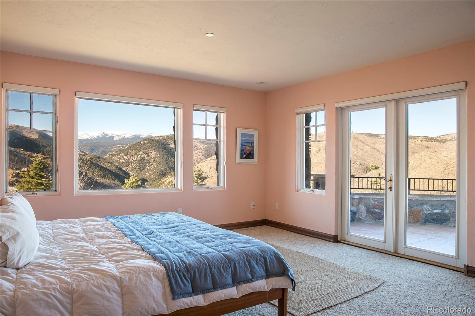 355 Mountain King Road Boulder, CO 80302 - Photo 17 of 33 a bedroom with a large window and a balcony