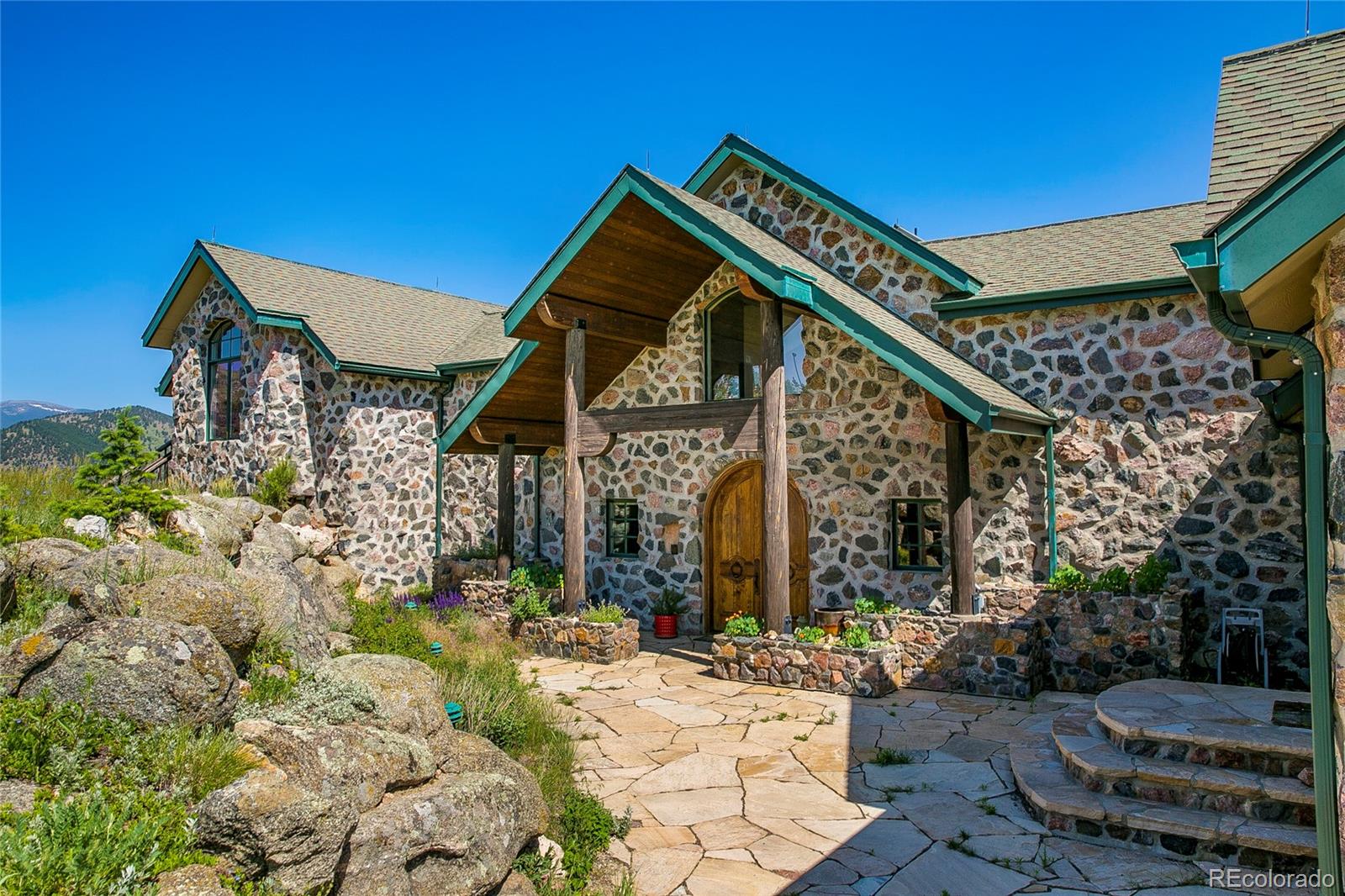 355 Mountain King Road Boulder, CO 80302 - Photo 3 of 33 a backyard of a house with outdoor seating