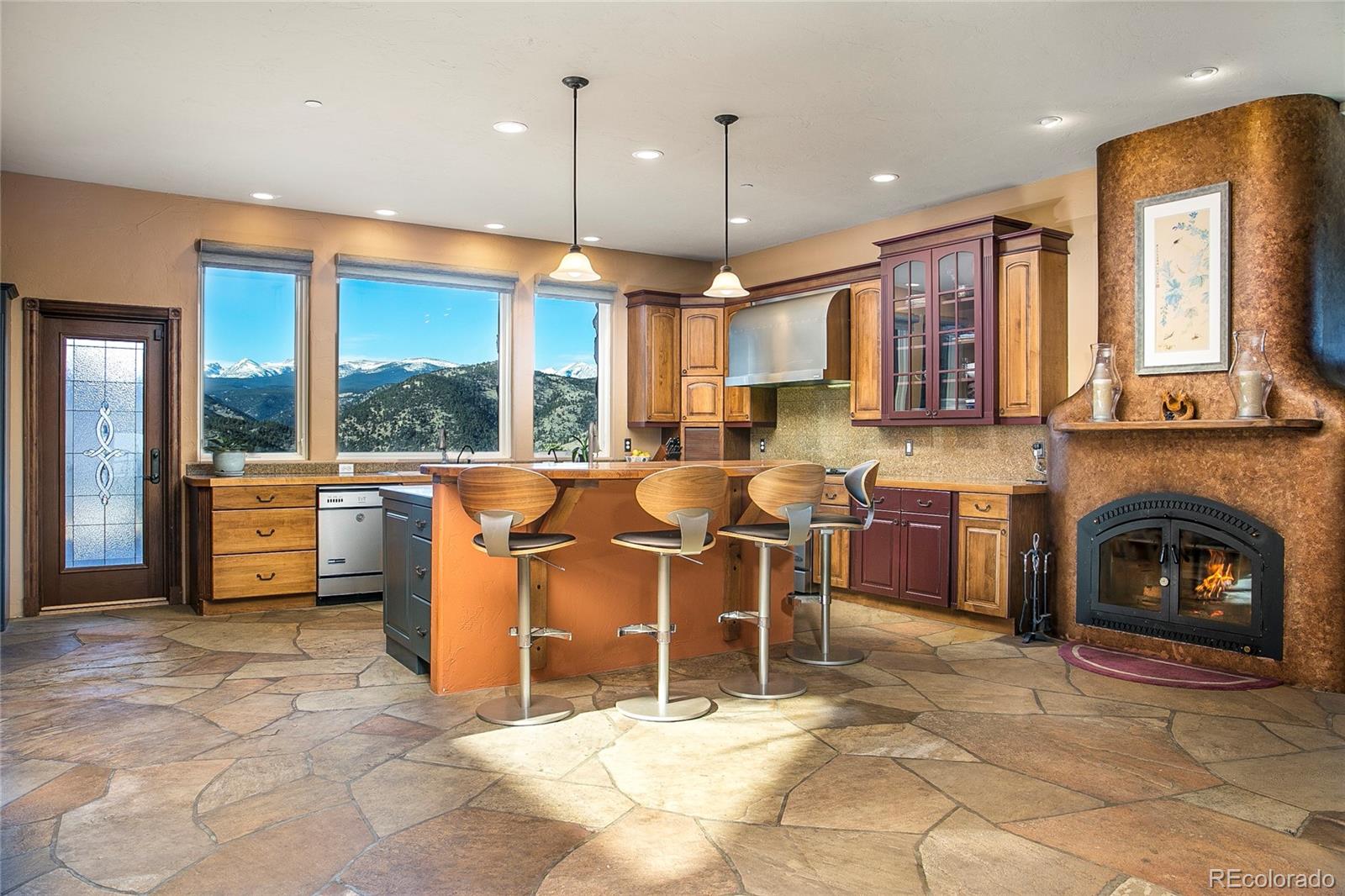 355 Mountain King Road Boulder, CO 80302 - Photo 9 of 33 a open kitchen with stainless steel appliances granite countertop a barbecue grill a dining table and chairs
