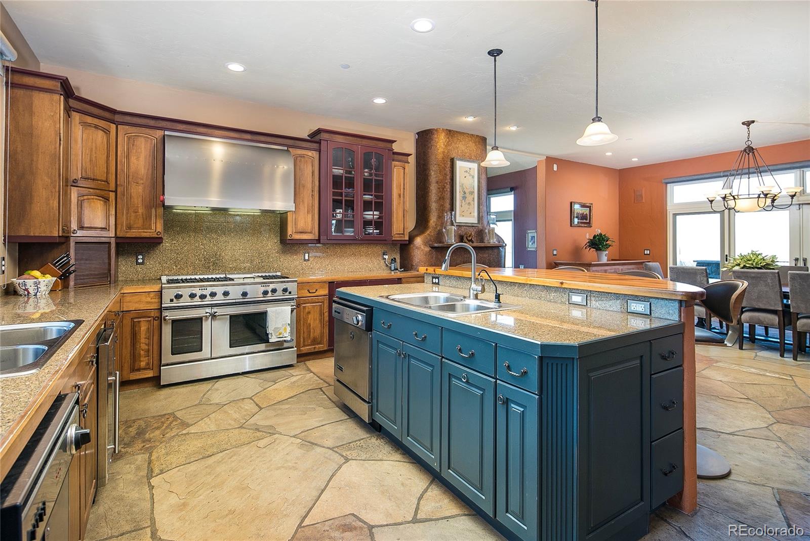 355 Mountain King Road Boulder, CO 80302 - Photo 10 of 33 a kitchen with stainless steel appliances granite countertop stove top oven and cabinets