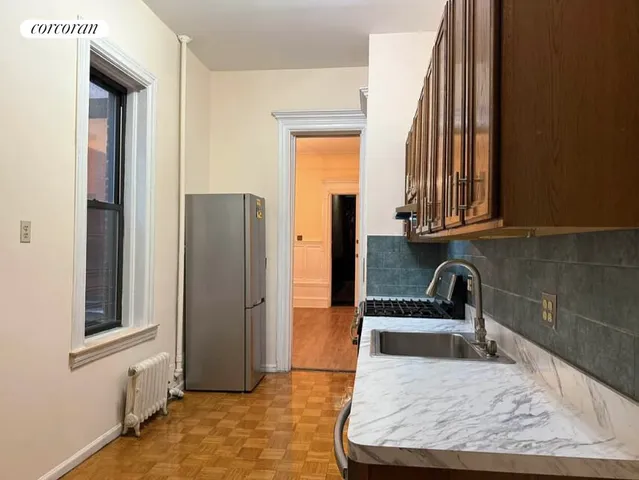 a kitchen with stainless steel appliances granite countertop a stove a sink and a refrigerator