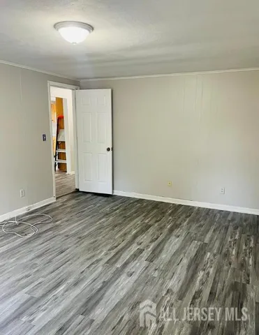 a view of an empty room and wooden floor