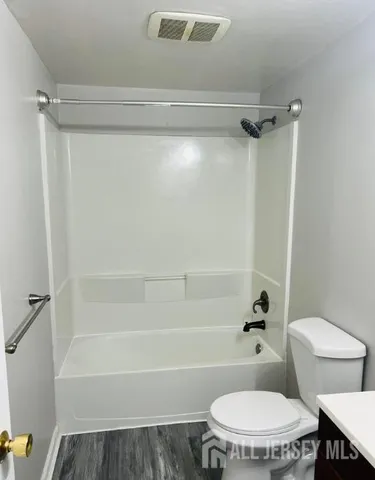 a bathroom with a toilet and a shower