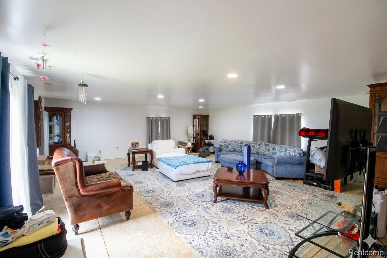 2568 Valentine Road Lapeer, MI 48446 - Photo 25 of 42 Spacious open-concept living area with recessed ceiling lighting, neutral tile flooring, and multiple windows providing natural light throughout