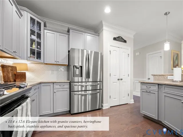 a kitchen with stainless steel appliances a refrigerator sink and cabinets