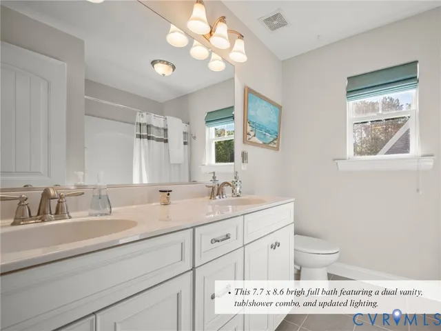 a bathroom with a granite countertop sink mirror and vanity