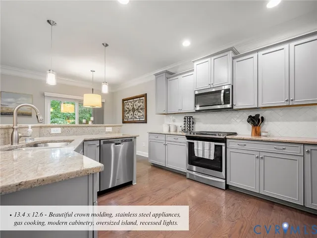 a kitchen with stainless steel appliances granite countertop a stove a sink dishwasher a microwave oven and a refrigerator