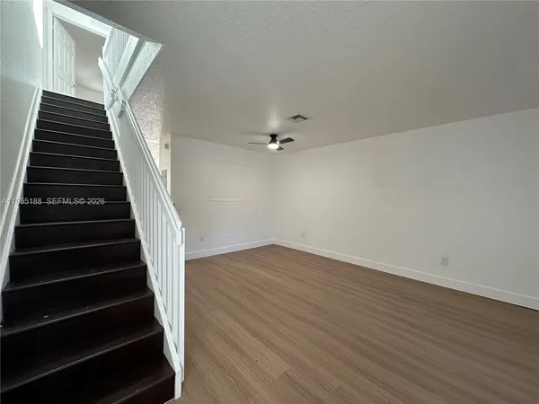 wooden floor in an empty room with stairs