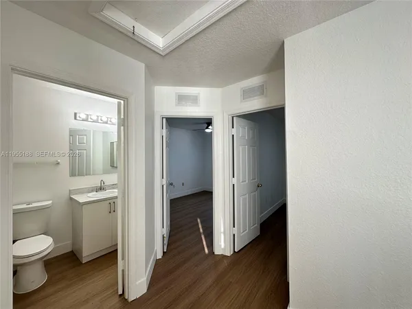 a bathroom with a toilet sink and a mirror