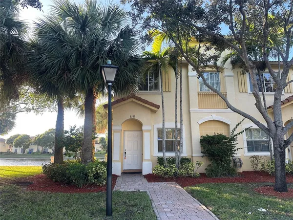 a view of a house with a yard and tree s