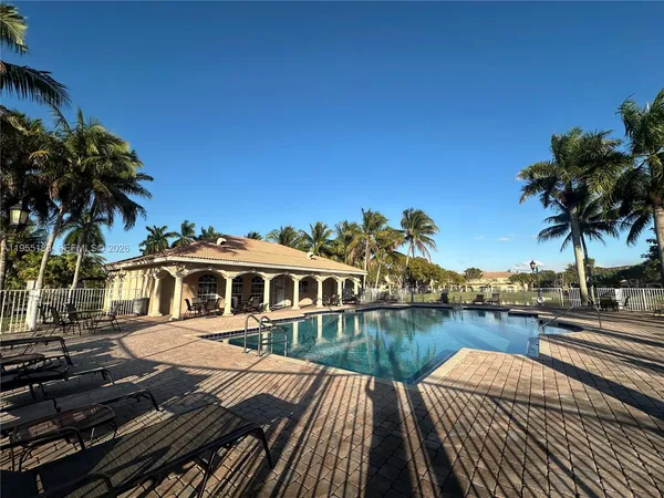 a view of swimming pool with lounge chair and lounge chairs