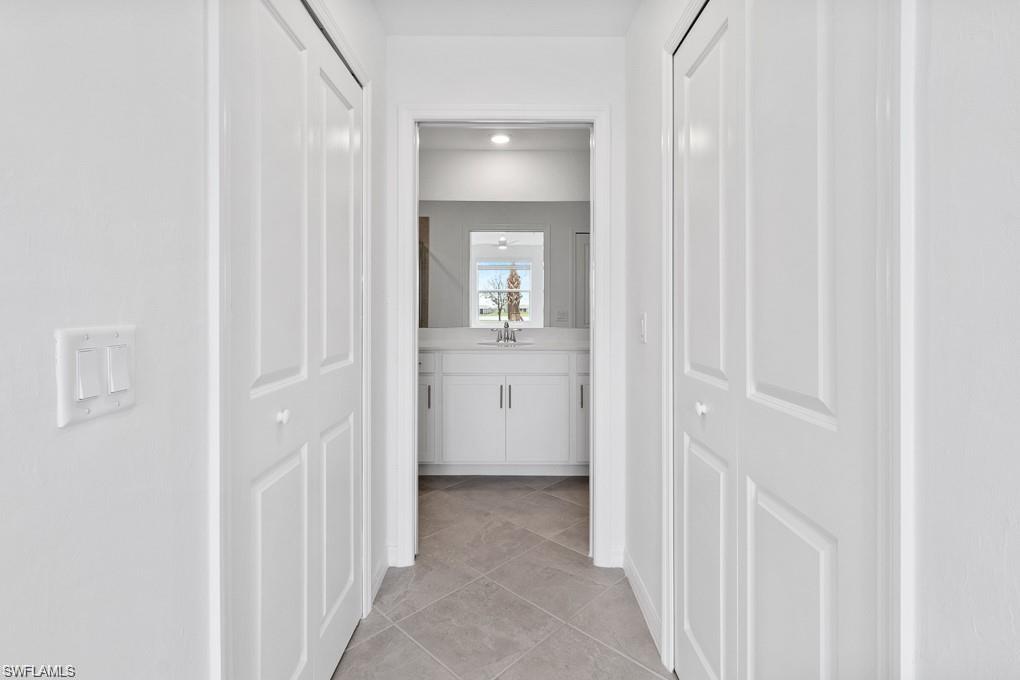 5651 Double Eagle Circle, Unit 4314 Immokalee, FL 34142 - Photo 10 of 41 Hallway featuring light tile patterned floors