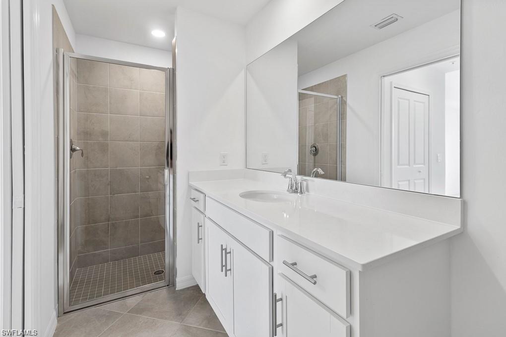 5651 Double Eagle Circle, Unit 4314 Immokalee, FL 34142 - Photo 11 of 41 Bathroom with vanity, a stall shower, light tile patterned floors, and recessed lighting