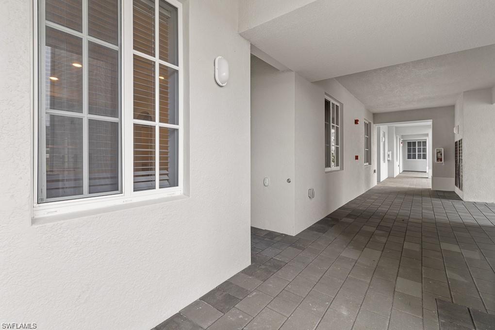 5651 Double Eagle Circle, Unit 4314 Immokalee, FL 34142 - Photo 16 of 41 Corridor with a textured wall and a textured ceiling
